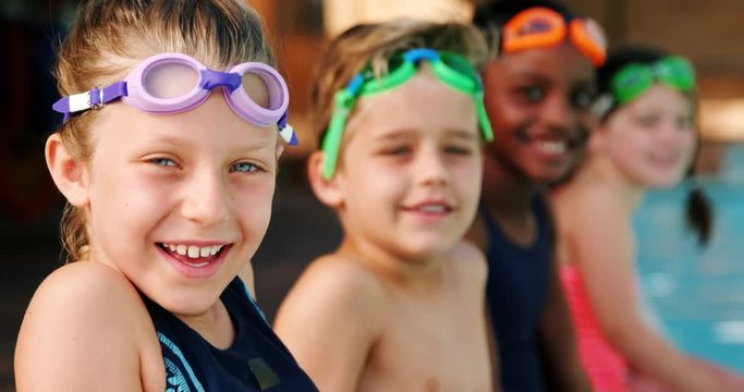 Smiling students wearing swimming goggles