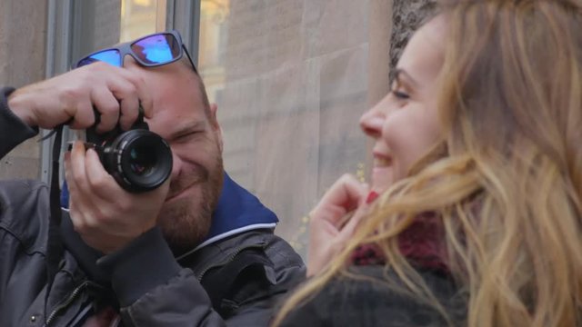 photographer taking photo shoot of blond woman in the street