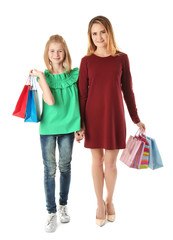 Mother and daughter with paper bags on white background