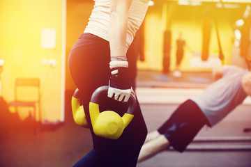 Close-up girl is Training with a dumbbell in the gym.concept of fitness
