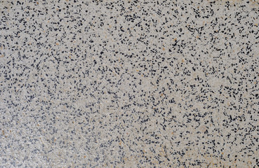 part of tile with black and white grains