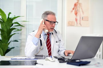 Doctor talking on the phone in his studio