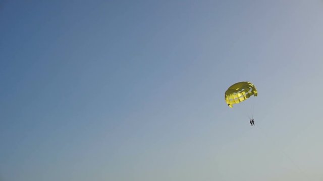 Parasailing over sea in blue sky