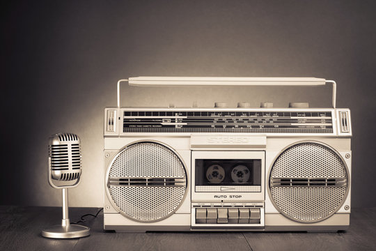 Retro stereo portable radio with cassette tape recorder and microphone. Old vintage style sepia photo