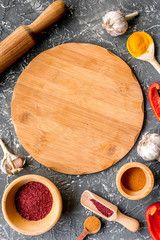 Professional kitchen with spices for cook on gray background top view
