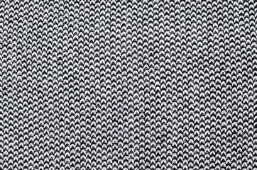 Grey woolen or tweed fabric for grunge background. Toned image.