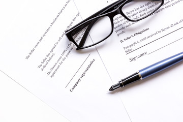 office desk with signing contract, glasses and pen for business top view