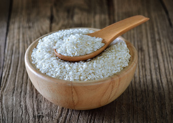 rice in  bowl on wooden surface