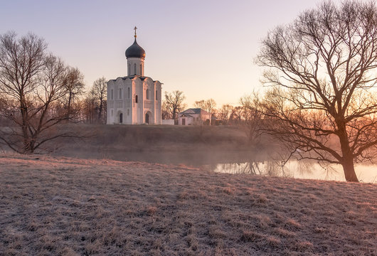 View to the Church of the Intercession of the Holy Virgin on the Nerl River in sunlight.