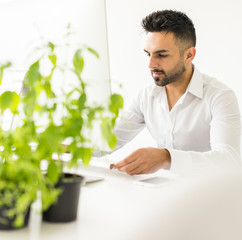 Young confident man working on computer