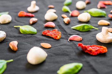 Selection of different Italian food ingredients against black background