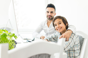 Fototapeta premium Man and boy on computer