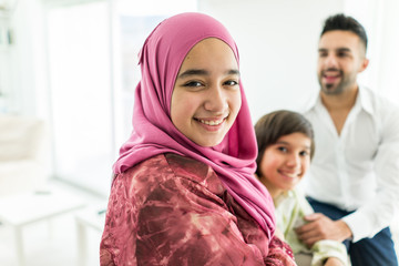Happy Arabic Muslim family at modern home having fun and good time together
