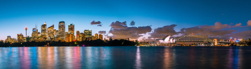 Sydney Opera House and Sydney Harbour Bridge illuminated at dusk