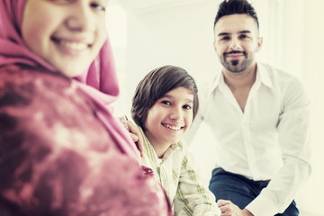 Happy Arabic Muslim family at modern home having fun and good time together