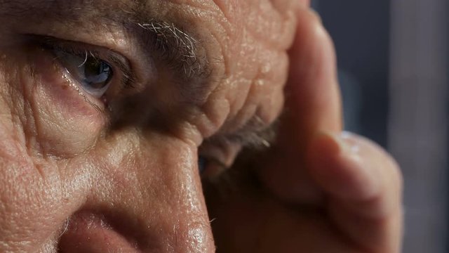Pensive and sad man's eyes. Close up on old man's eyes