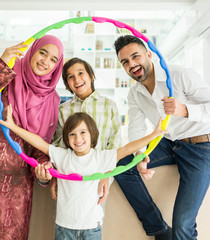 Happy Arabic Muslim family at modern home having fun and good time together