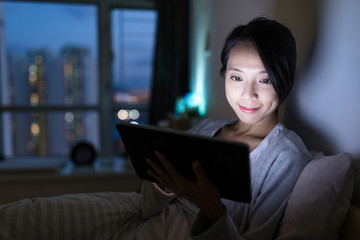 Woman using digital tablet in home