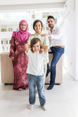 Happy Arabic Muslim family at modern home having fun and good time together