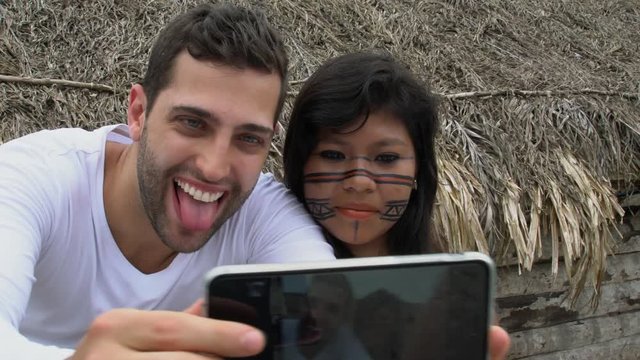 Tourist taking a selfie with Brazilian Natives - Indigenous People - in a Tupi Guarani Tribe, Brazil