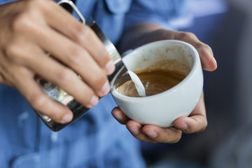 barista make latte art selective  focus