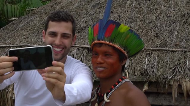 Tourist taking a selfie with a Brazilian Native - Indigenous Man - in a Tupi Guarani Tribe, Brazil