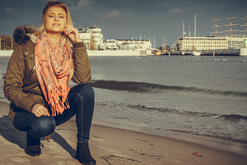 Woman relaxing on beach, cold day