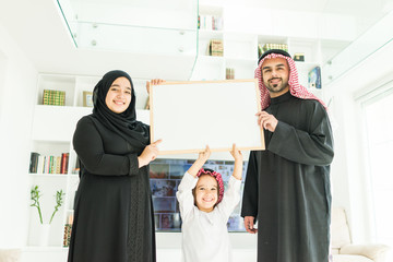 Happy Arabic Muslim family at modern home having fun and good time together