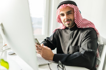 Arabian Gulf young businessman at office working on computer