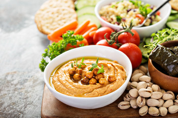 Hummus and vegetables platter with grain salad