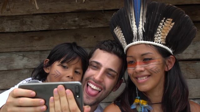 Tourist taking a selfie and having fun in a Tupi Guarani Tribe, Brazil