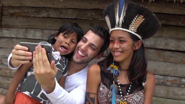 Tourist taking a selfie and having fun in a Tupi Guarani Tribe, Brazil