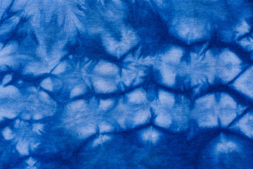 Pattern of blue dye on cotton cloth, Dyed indigo fabric background and textured