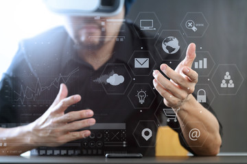 businessman wearing virtual reality goggles in modern office with mobile phone using with VR headset with screen icon diagram
