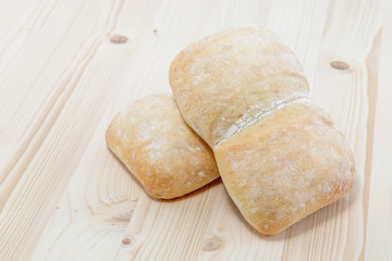 Two ciabatta bread on a wood board