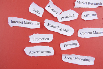 Marketing conceptual word on torn paper.