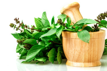 Sweet basil and hot basil in the wooden mortar
