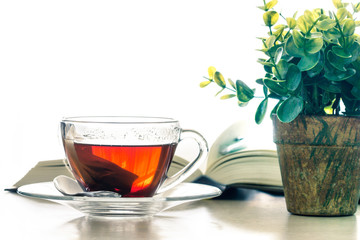 Close up warm black tea cup on  wooden table in living room , relax with tea time concept