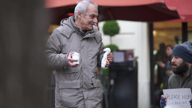 People's Kindness goodness old man brings breakfast to a homeless in the street