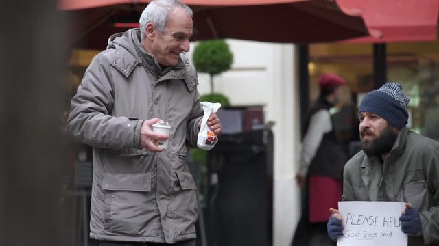 Old Gentleman brings breakfast to a homeless and caressing his face