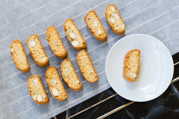 Baking tray with fresh baked biscotti cantuccini or cantucci, Italian almond sweets biscuits (cookies) traditionally served with a drink, coffee or vine. Copy space.Top view.