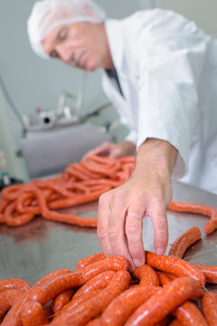 Butcher making sausages