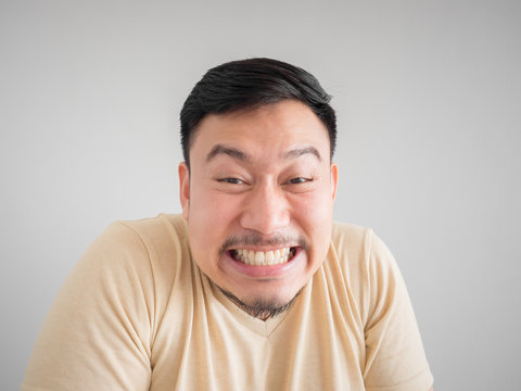 Headshot of funny guilty Asian man.