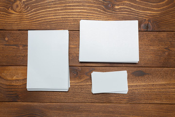 blank white business cards on wooden background.