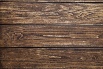 Fototapeta premium Background of three horizontal boards of dark wood with knots and traces of processing
