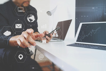 businessman working with smart phone and digital tablet and laptop computer in modern office