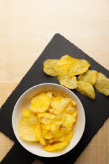 Potato chips in bowl on a table