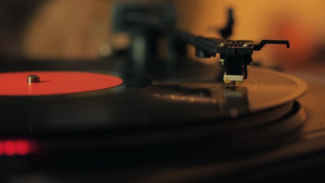 A retro-styled spinning record vinyl player. 4k. Close up.