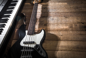 Fototapeta na wymiar piano and guitar on wooden background closeup