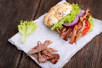 Pulled pork burger with coleslaw tomato, onion and fresh bread.